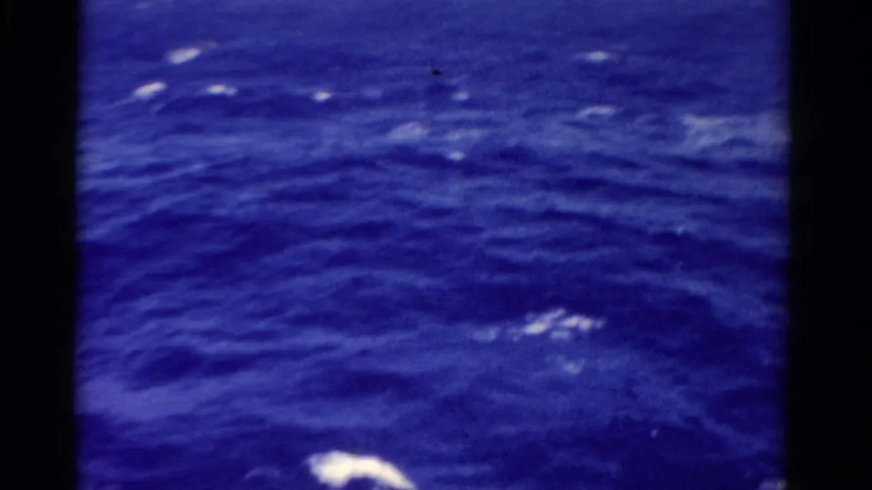 1975 8mm Florida footage showing blue open water with scattered white foam seen from a moving vessel.