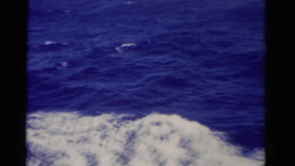 1975 Florida 8mm frame with churning sea water and white foam near the bottom edge.