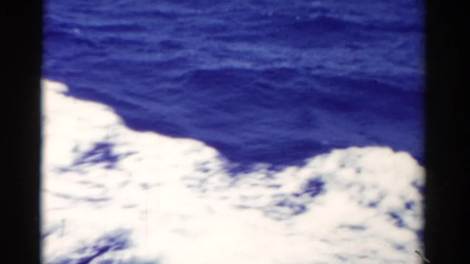 1975 Florida 8mm home-movie view of bright foamy wake spreading over deep blue ocean water.