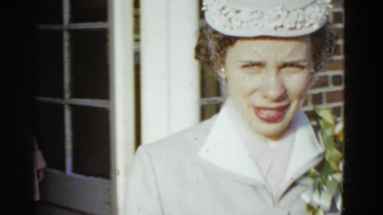Close view of the woman facing the camera beside the brick doorway.