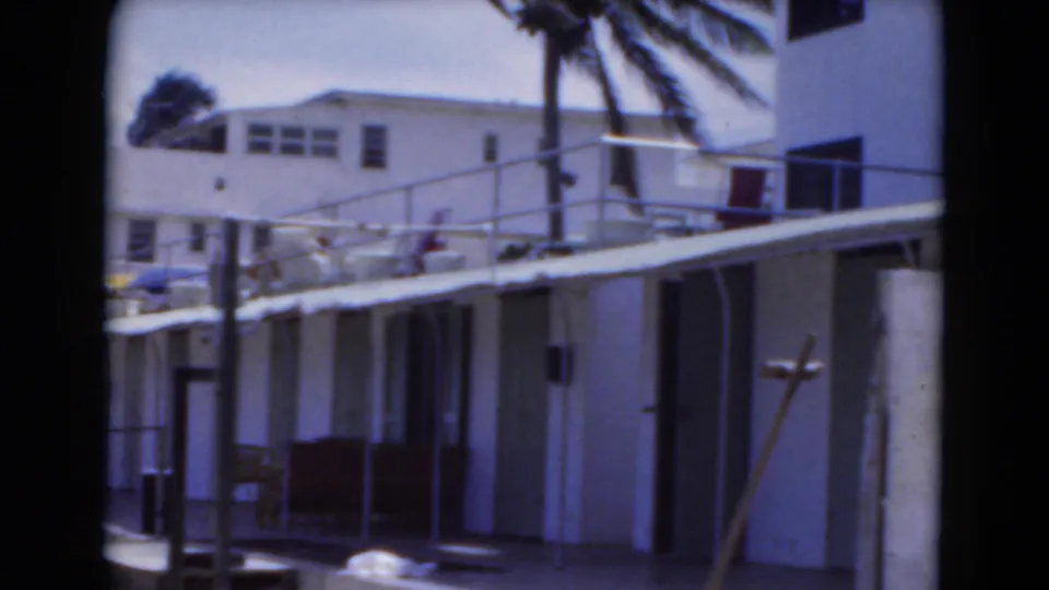 A palm-lined building complex near the beach appears in the final 1975 Florida frame, suggesting vacation lodging or a resort setting.