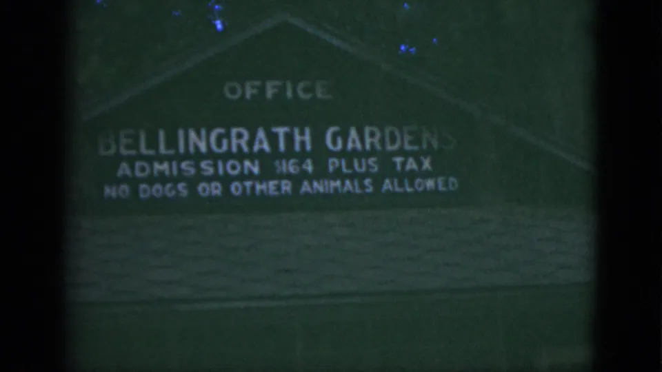 Soft 1975 8mm close view of the Bellingrath Gardens sign showing office, admission, and no animals allowed text.