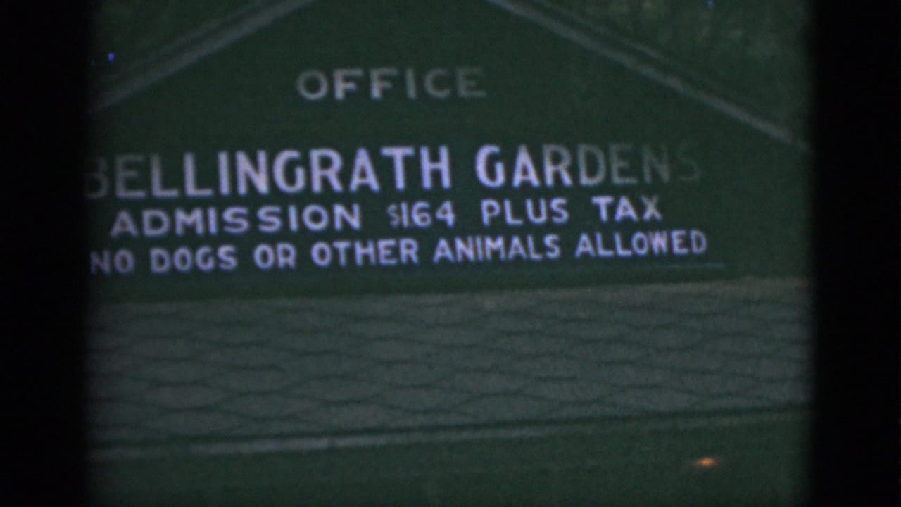 Closer view of the Bellingrath Gardens sign with admission and rules text.