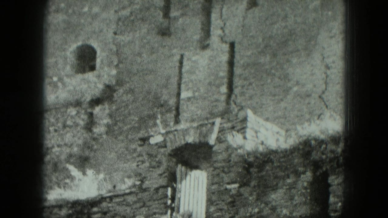 Damaged brick wall with arched opening and broken masonry seen through 8mm film borders.
