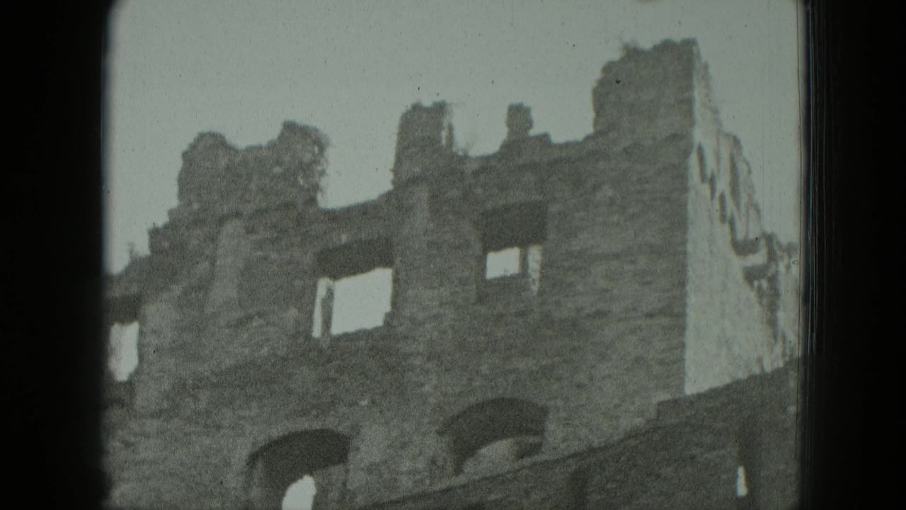 1951 Germany 8mm frame showing a weathered stone ruin with arched openings, broken windows, and dark film borders.