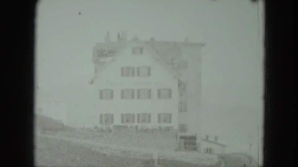 1951 Germany home-movie frame showing a large multi-story hillside house softened by mist and exposure.