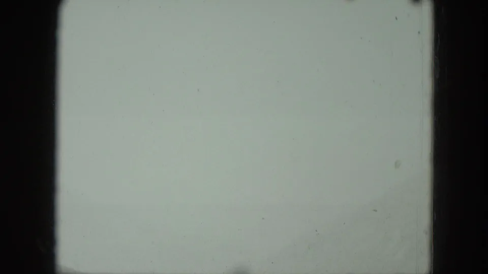 Overexposed or blank 8mm frame from the 1951 Germany clip, with visible gate edges and film specks.