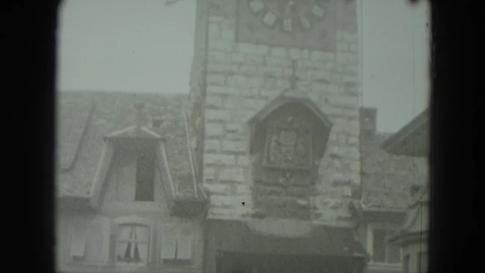 A static 1951 West Germany frame shows the clocktower facade, nearby dormers, and steep roofs in muted winter light.