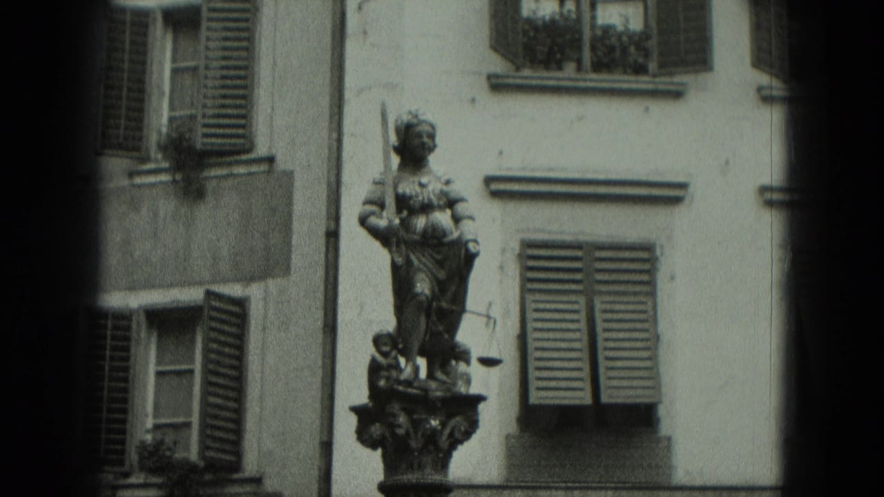 Public statue beside shuttered windows on an old building facade.