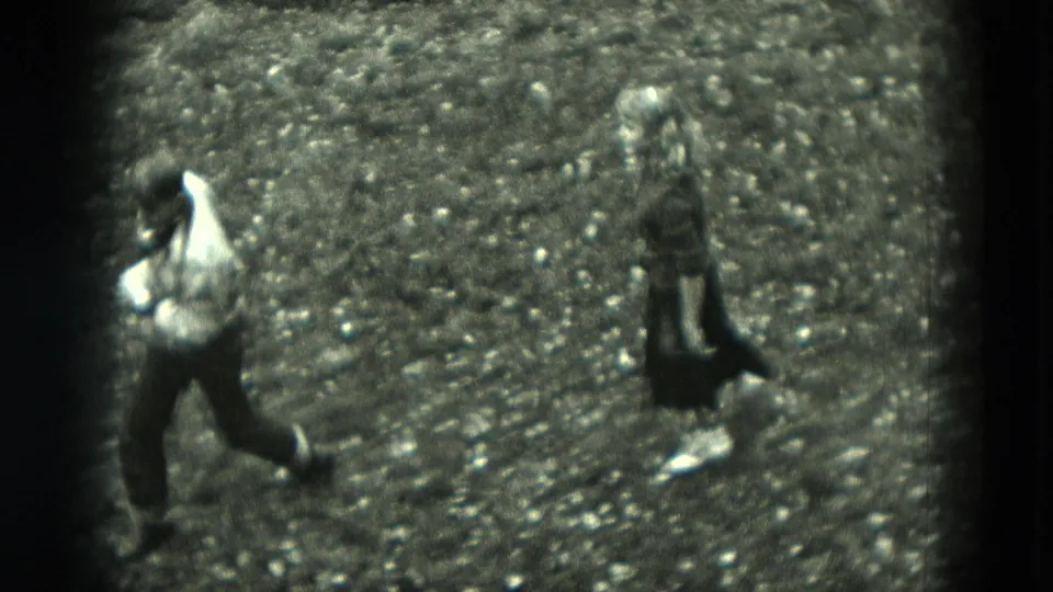 The final frame shows the couple separated on the gravel path, still in motion within grainy 1951 West Germany 8mm home-movie footage.