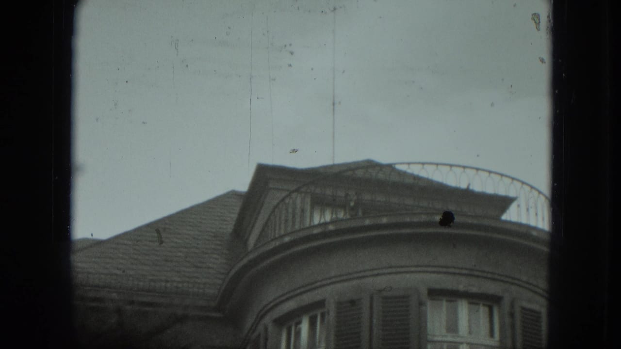A curved upper-story balcony and roofline appear with no clear person visible.