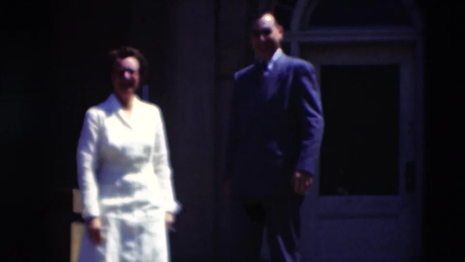In 1951 Paducah home-movie footage, a woman in a white uniform and a man in a dark suit appear outside a building entrance.