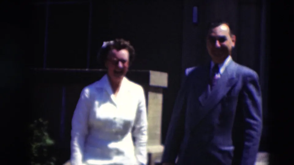 The final frame keeps the two adults in view as they continue walking outside a Paducah building, with faces visible but softly resolved.