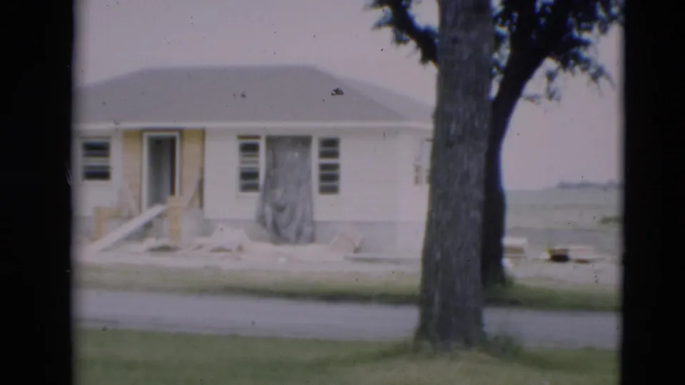 1951 Paducah residential construction view showing a small single-story house with unfinished entrance work, bare ground, a tree, and street foreground.
