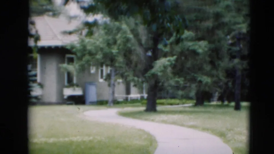 The final 1951 Paducah frame shows a concrete path curving through a residential lawn toward a pale house shaded by trees.