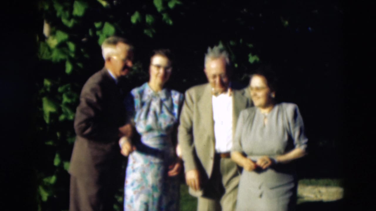 Four adults in formal mid-century clothing stand together outdoors in the 1951 Paducah, Kentucky home movie.