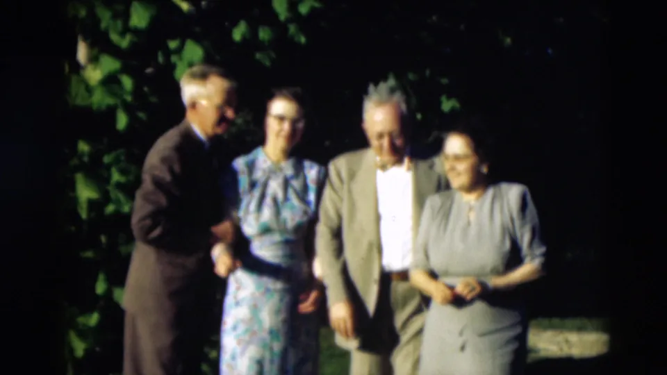 Four adults in formal mid-century clothing stand together outdoors in the 1951 Paducah, Kentucky home movie.