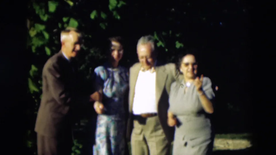 In the Paducah 1951 home movie, four adults pose outdoors while one woman gestures and the group continues shifting.