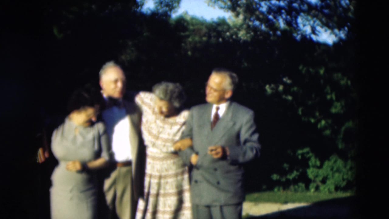Adults in mid-century formal clothing stand close together in Paducah, Kentucky, appearing to prepare for a group portrait.