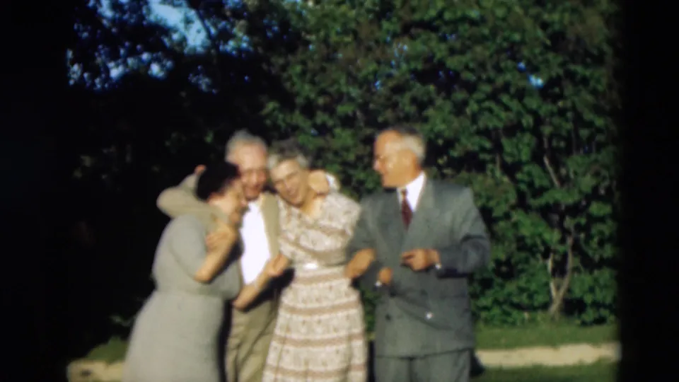 In the supplied Paducah 1951 scene, older friends laugh as one woman leans in and the group keeps their arms linked outdoors.