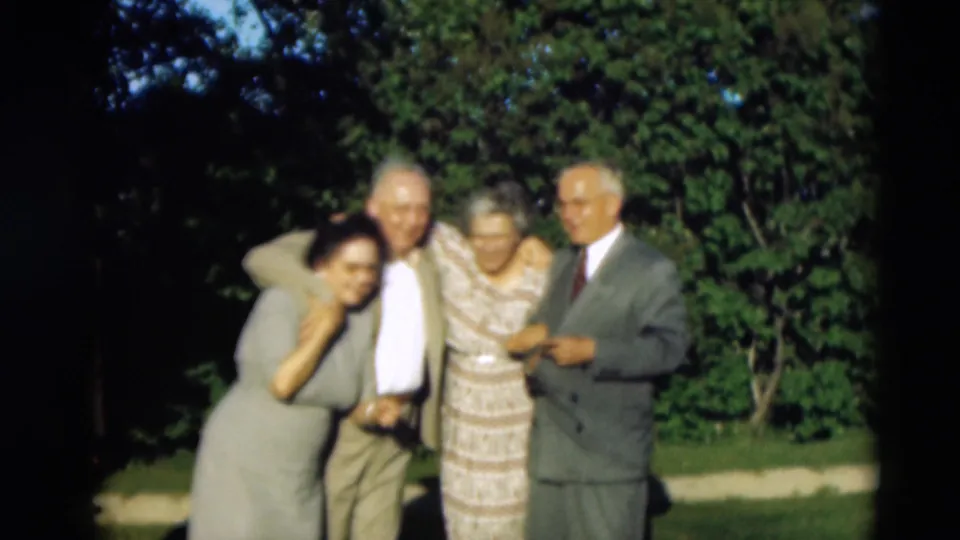 Four older adults in mid-century home-movie footage huddle together smiling in Paducah, Kentucky, according to supplied metadata.