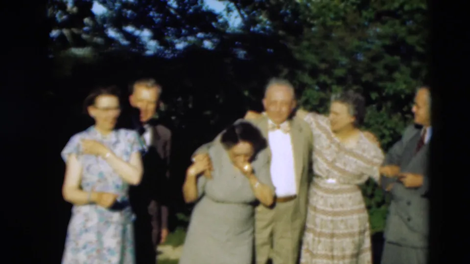 A larger group of elderly adults appears outdoors in 1951 Paducah footage, with one woman bending forward as others stand nearby.
