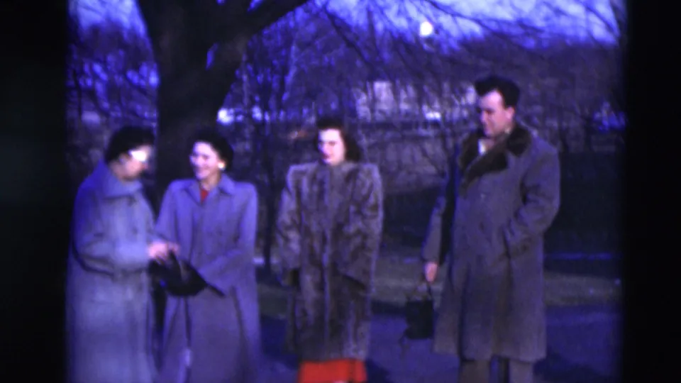 In 1951 Paducah, Kentucky, three women and one man appear outdoors in winter coats beside bare trees and a quiet street.