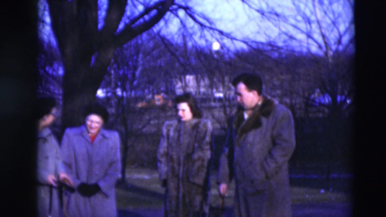 The group remains gathered on a Paducah residential street, wearing heavy coats under a blue-tinted winter sky.