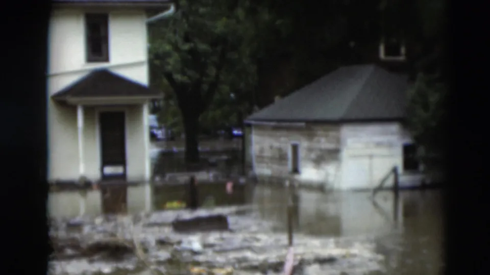 Paducah, Kentucky flooding in 1951 appears around residential structures, with debris visible in the water.