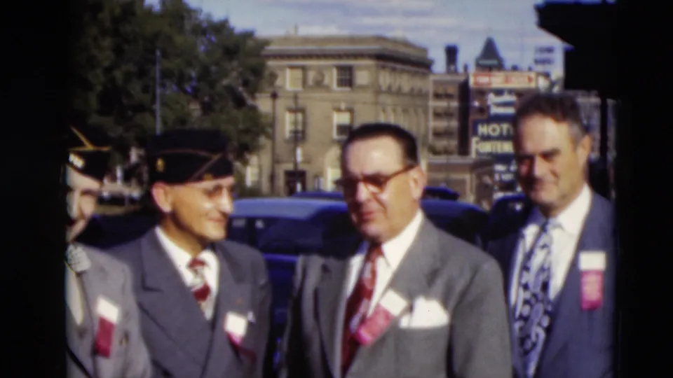 Three formally dressed men with caps, ties, and badges stand together in the supplied Paducah, Kentucky 1951 home-movie footage.