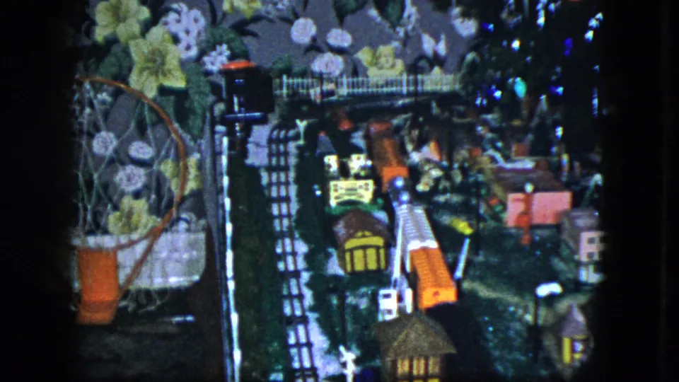Final 1951 Cleveland frame of the indoor train display, showing small buildings, track details, and the floral wallpaper setting.