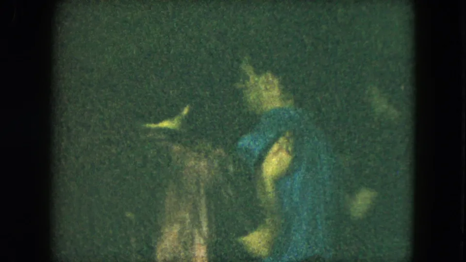Cleveland, Ohio 1951 home-movie frame showing a woman in a blue dress dancing among other adults indoors.