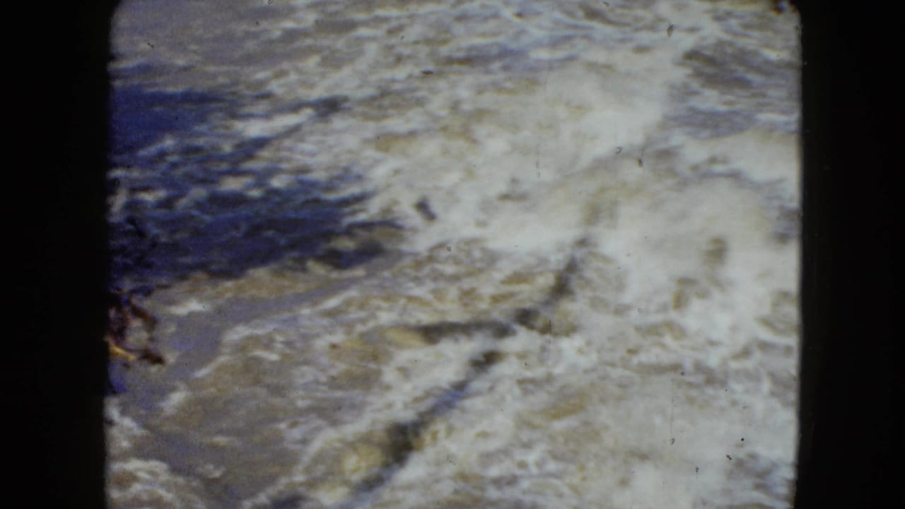 1951 8mm Cleveland-area footage shows churning whitewater and darker current within rounded home-movie frame edges.