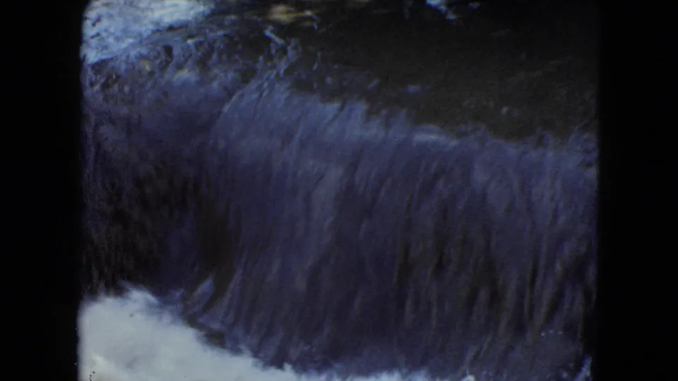1951 Cleveland-area 8mm frame showing dark, fast water dropping over a low ledge and churning into white foam.