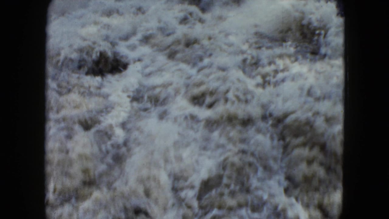 1951 Cleveland 8mm footage shows close, turbulent floodwater filling the frame with pale foam and muddy motion.