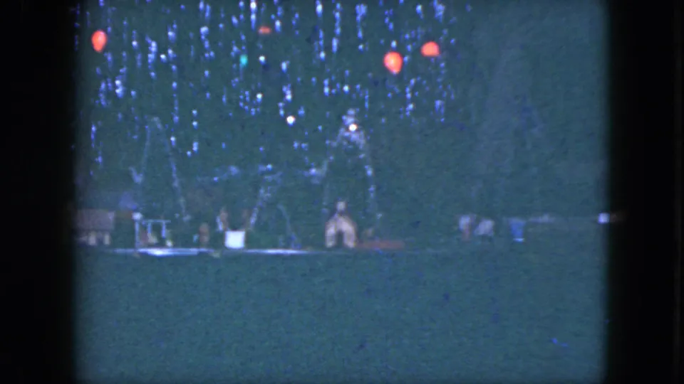 A 1951 Cleveland 8mm frame shows the train layout from a similar angle, with small buildings and red lights visible.