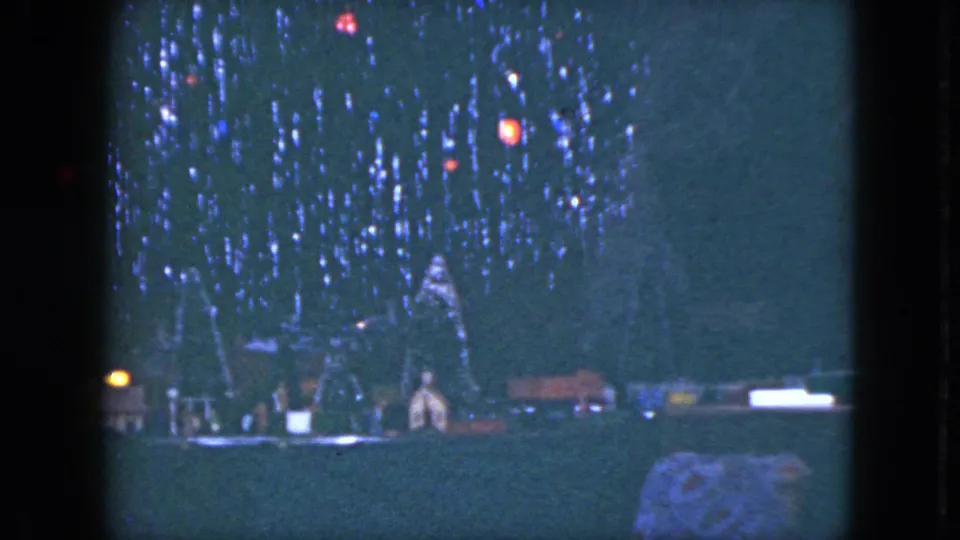 1951 Cleveland 8mm still showing colored tree lights and a small holiday village or train-set-like display at the base.