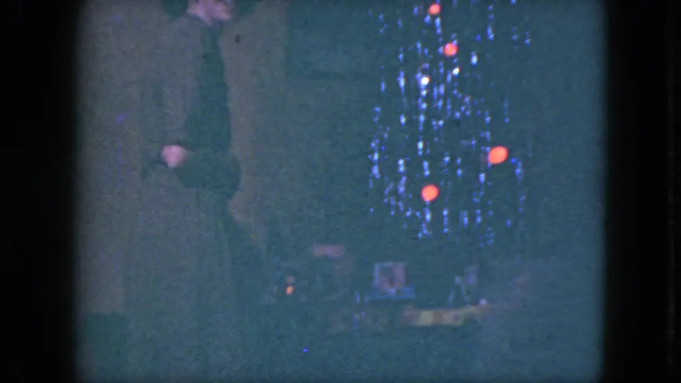 The final frame shows the woman partly obscured beside the Cleveland Christmas train set, surrounded by blue and red-orange lights.