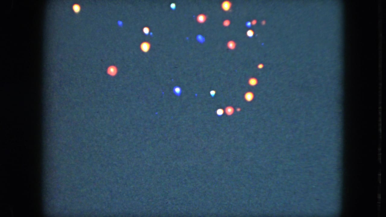 Colored points of light scattered against a dark blue background.