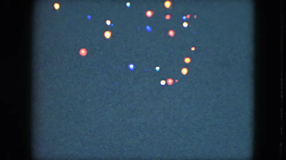 Colored holiday lights glow against a dark background in the 1951 Cleveland 8mm home-movie footage.