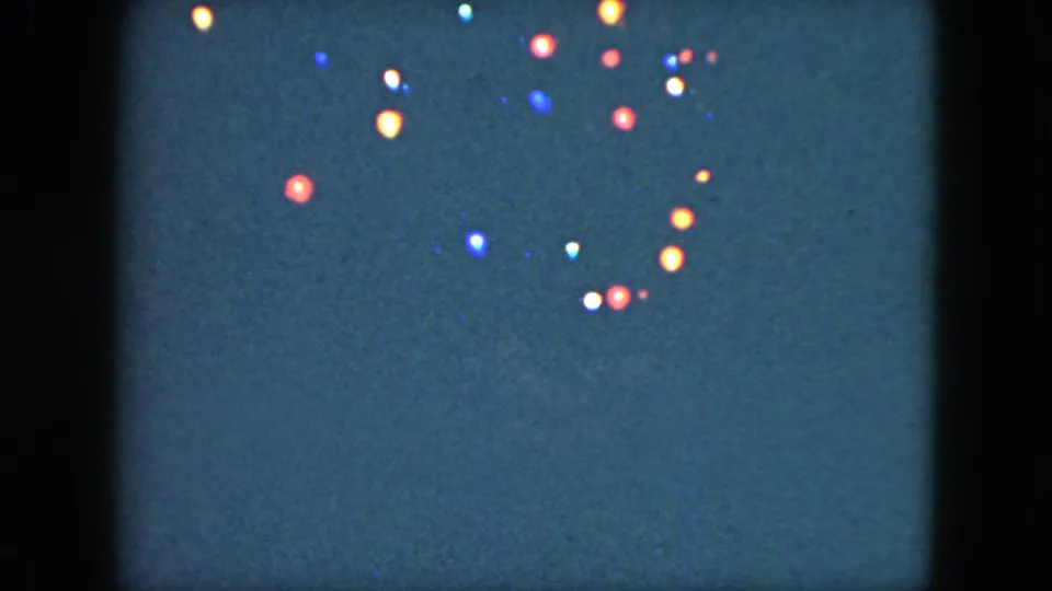 The final frame shows glowing colored holiday lights grouped on a dark background in 1951 Cleveland 8mm footage.