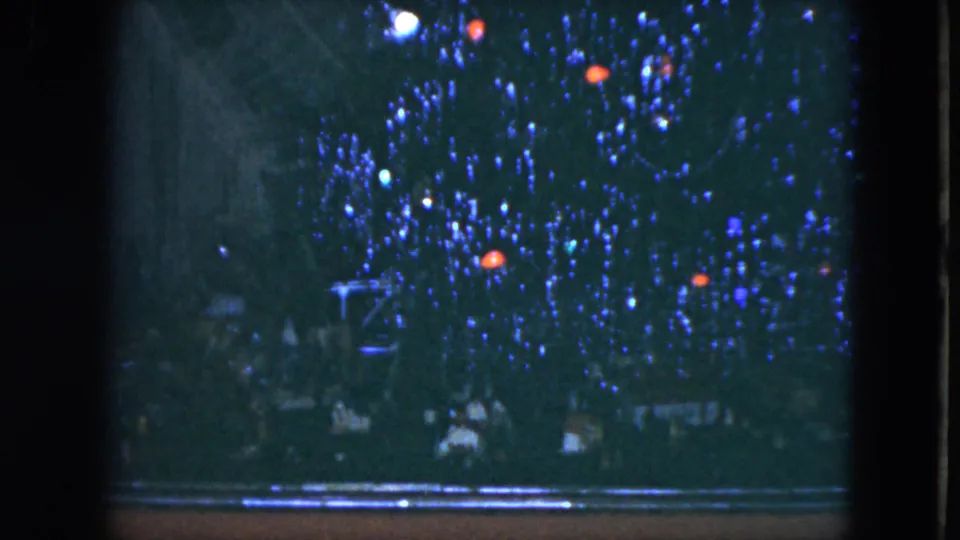 Blue-lit Christmas tree or display in Cleveland, Ohio, filmed in 1951 with dark frame edges and indistinct people near the bottom.