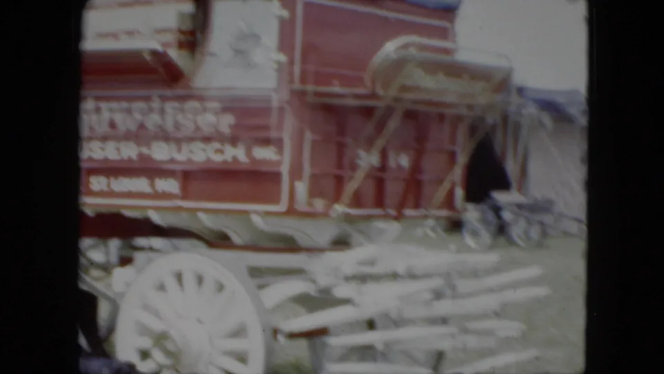 Close 1951 Cleveland circus setup view of an Anheuser-Busch wagon, white wheels, and nearby equipment or tack.