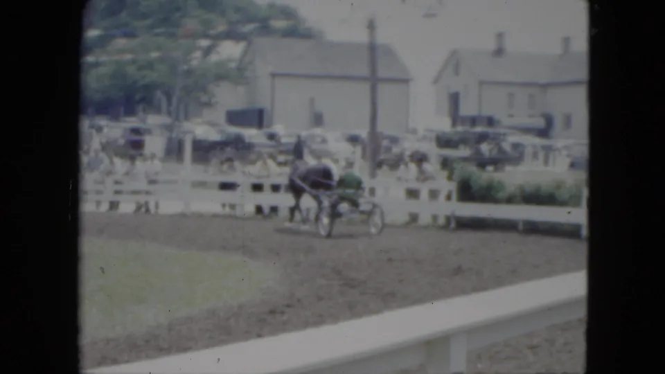 A horse-drawn chaise cart rounds the dirt track in the 1951 Cleveland scene, with spectators clustered behind a white fence.