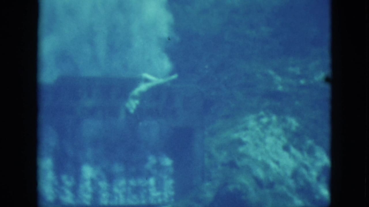 Swimmer floats underwater near the upper center of a blue-tinted frame.