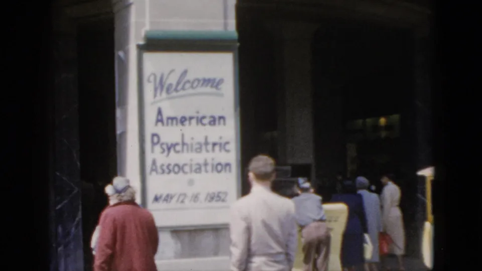 8mm color footage, Quebec 1952: final frame shows the APA conference welcome sign and a group of period-dressed attendees in hats and coats moving toward the building entrance.