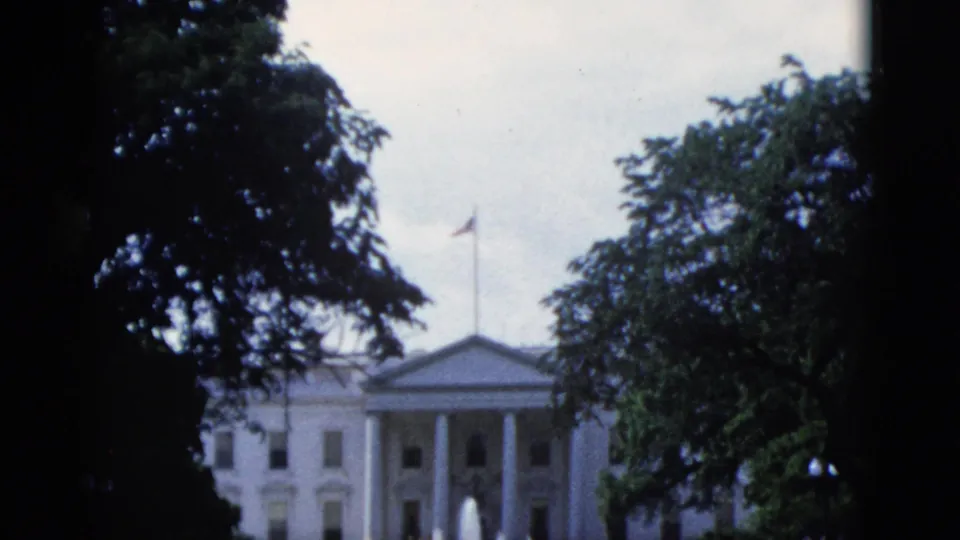 White House North Portico, Washington DC, circa 1952, with active north lawn fountains and an American flag visible above the classical pediment.