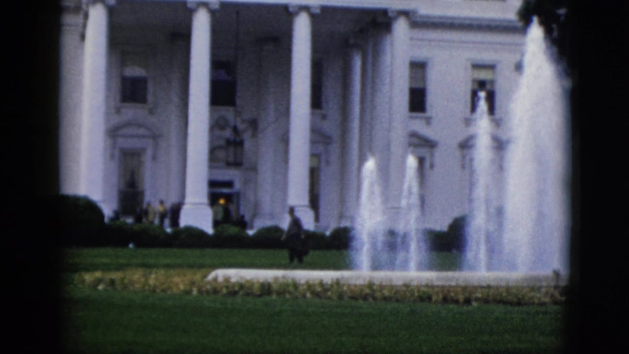 White House North Portico with active fountain and small figures on the North Lawn, 8mm color film.