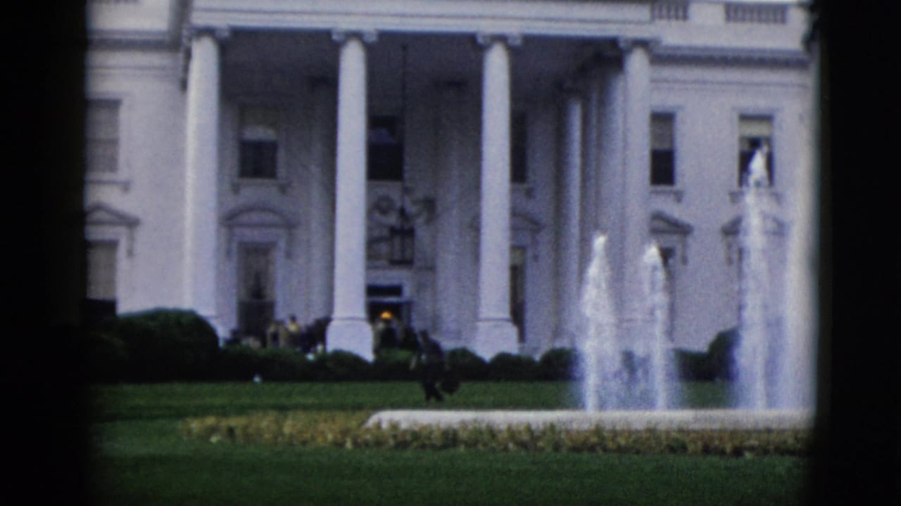 8mm color view of the White House North Portico, c. 1952, with the fountain active and a small figure near the building entrance on the right.
