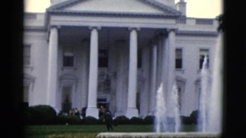 Closer 8mm color frame of the White House North Portico, c. 1952, showing the fountain active and a few figures near the front steps.